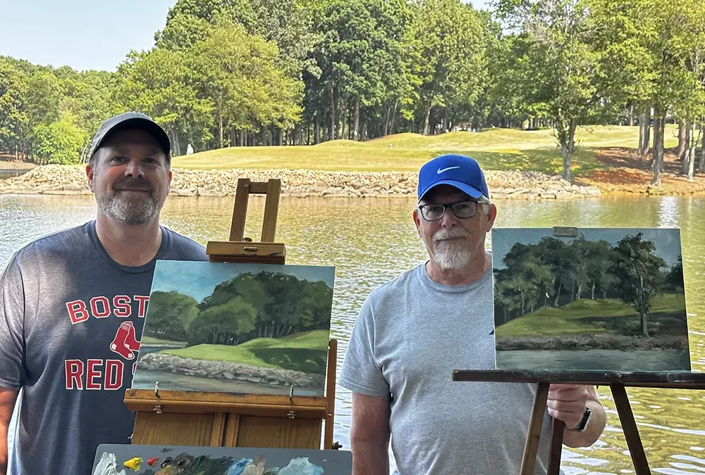 Jason & Richard Clewell painting outdoors.